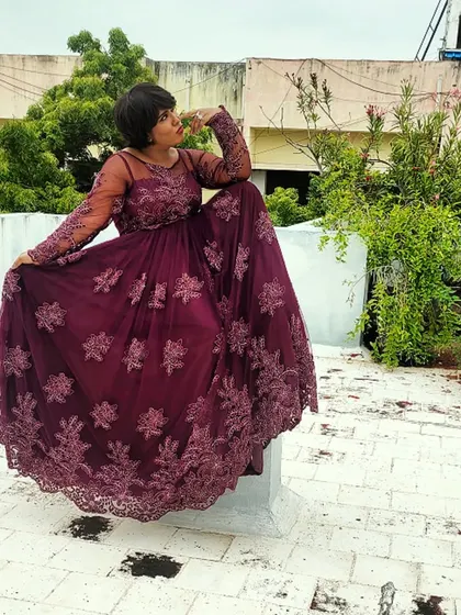 A majestic pose on the rooftop in the purple gown. This shot has a sense of drama and power.