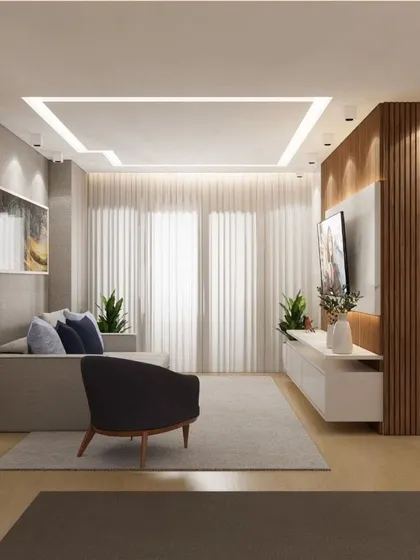 A bright living room with a simple, effective layout, featuring a floating TV console and a comfortable sofa.