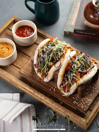 This shot shows how food can be presented in a cafe setting, complete with books and other props. It creates a lifestyle feel, helping customers imagine themselves enjoying the dish.