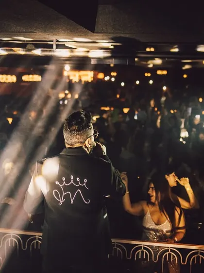 A shot from behind Mika Singh, showing his perspective of the cheering crowd. This unique angle provides a dynamic view of the concert experience.