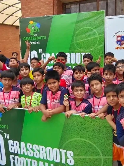A crowd of our young players celebrating behind a banner for the 10th AFC Grassroots Football Day. The future of Indian football is bright.