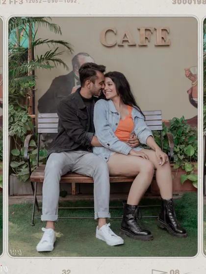 A cozy shot of a couple on a cafe bench, edited with a film-like filter to enhance the romantic mood.