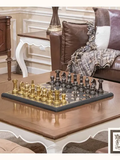 This gold and black classic chessboard is more than just a game, it's a stunning centerpiece. Placed on a coffee table, it invites both strategic play and admiration for its elegant design.