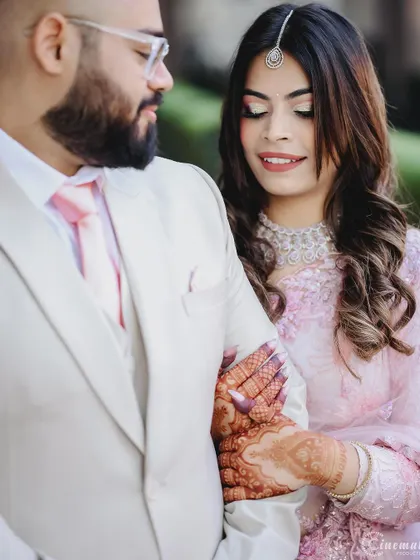 A close-up shot focusing on the couple's connection and the intricate details of the bride's henna and jewelry.