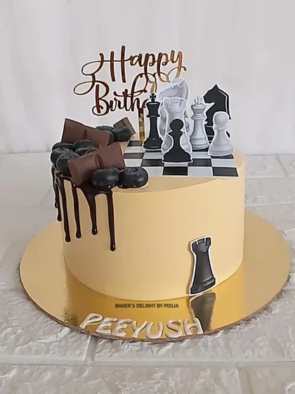 Checkmate. This chess-themed cake is a strategic choice for a birthday celebration, featuring a chessboard top, edible pieces, and a rich chocolate drip.