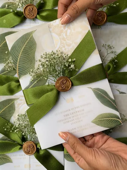A duplicate image of the elegant green leaf vellum invitation.