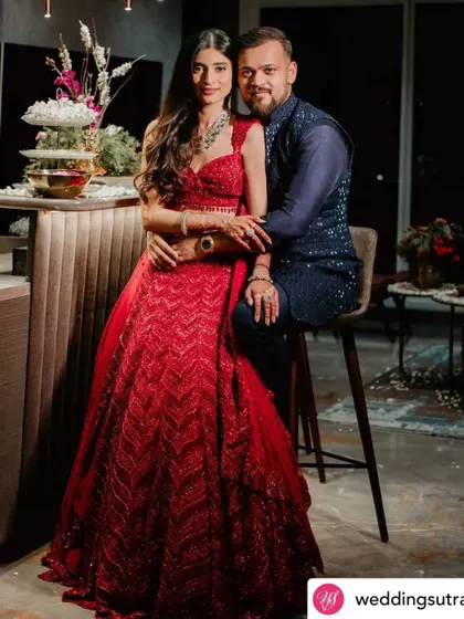 A gorgeous bride in a celebratory red lehenga for her engagement. The makeup is glamorous yet elegant, setting the perfect tone for the wedding festivities.