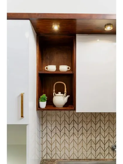A detail shot from the Raghuvani home kitchen, showing an open wooden niche perfect for displaying a teapot and cups, adding a personal and decorative touch.