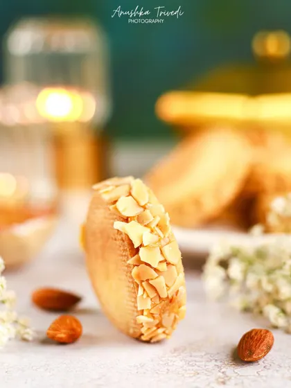 A close-up shot of an almond cookie, with beautiful soft lighting and a shallow depth of field to create a dreamy effect.