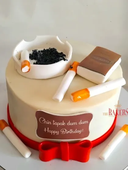 A quirky cake for a smoker's birthday, with the fun message "Chin tapak dum dum." This design features an edible ashtray and cigarettes, perfect for a celebration with a sense of humor.