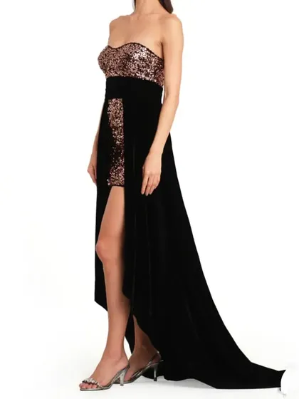 A side view of the black and rose gold gown, highlighting the high slit and sequined mini skirt underneath.