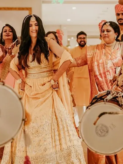 The bride makes a grand entrance, dancing to the beat of the dhols. We focus on capturing the energy and excitement of these key moments.