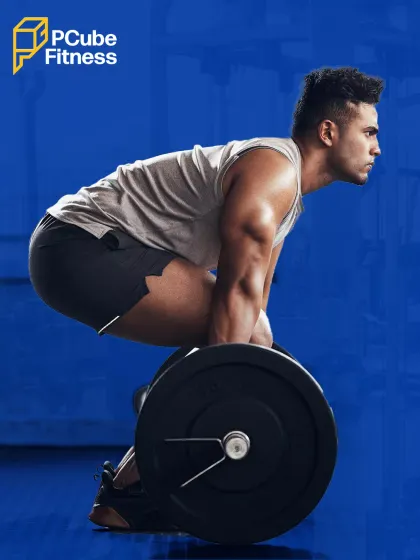A man prepares for a heavy deadlift, demonstrating the focus and proper form required for this powerful full-body exercise.