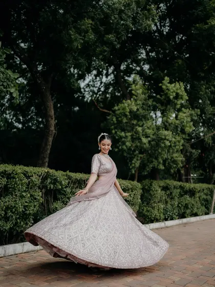 A joyful twirl in a beautiful lehenga. This shot captures the movement and elegance of the outfit, as well as the bride's happy spirit.