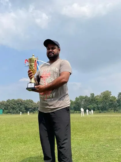 A tribute to our passionate coaching staff. A coach proudly holds a championship trophy, symbolizing the dedication and expertise that guides our teams to victory.