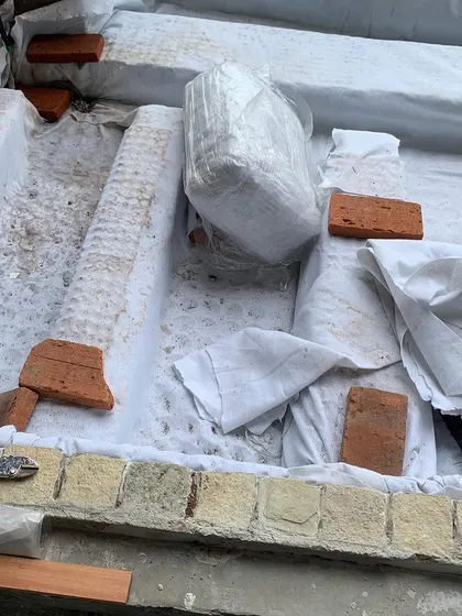 Preparing the foundation for a large planter bed. We use a waterproofing layer and drainage cells to ensure the structure is sound and the plants stay healthy.