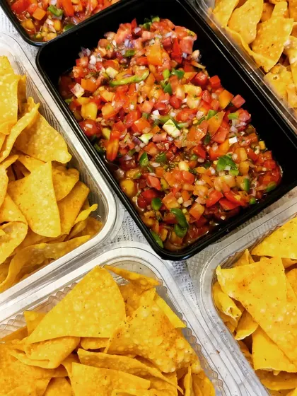 A perfect party snack of homemade nacho chips served with generous portions of our fresh and spicy tomato salsa. We also offer a pineapple salsa variation.
