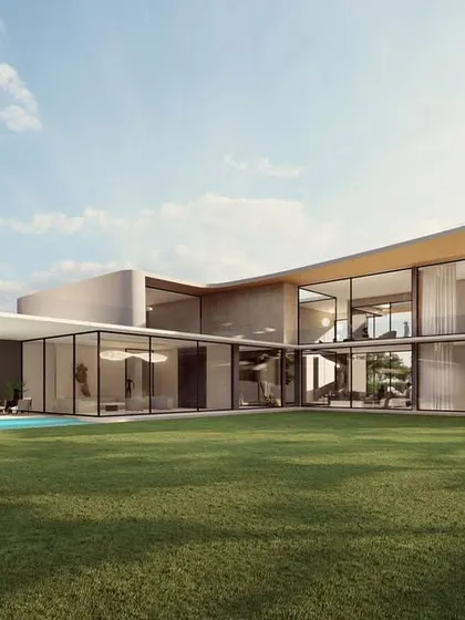 The rear of the "Galaxy Fall" home opens up completely to a large lawn and pool area. The L-shaped plan maximizes views and creates a sheltered outdoor living space, embodying a luxurious, resort-style feel.