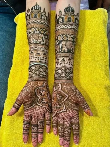 This design features the iconic Taj Mahal at the top of the forearms, a beautiful symbol of love, combined with traditional elephant and floral patterns.