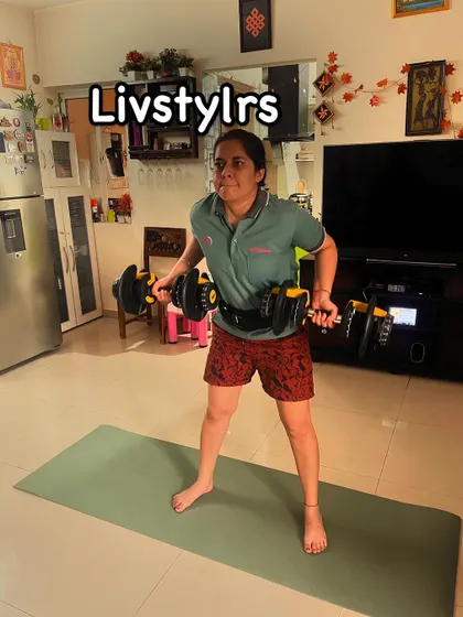 A client uses adjustable dumbbells for a bent-over row, a powerful exercise for building back strength and improving posture.