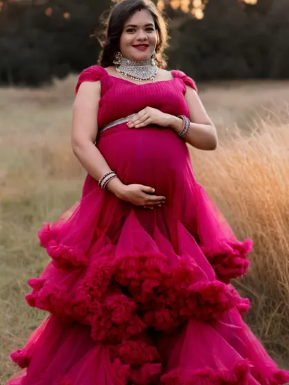 A detailed look at the ruffled skirt of our pink maternity gown. This dress is designed to add volume and texture to your photos.