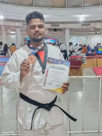 Coach Prabakaran with his international bronze medal, leading by example.