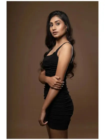 A simple, standing portrait that clearly shows the model's physique and presence. This is a fundamental shot for any modeling portfolio, providing a clear look for casting directors.