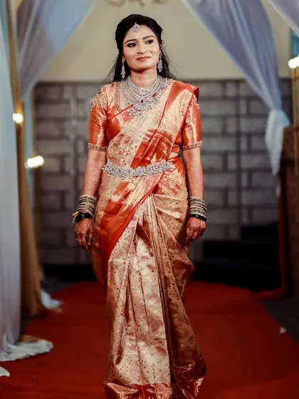 Walking down the aisle with grace. The flow of the saree and the sparkle of the jewellery create a truly memorable bridal moment.