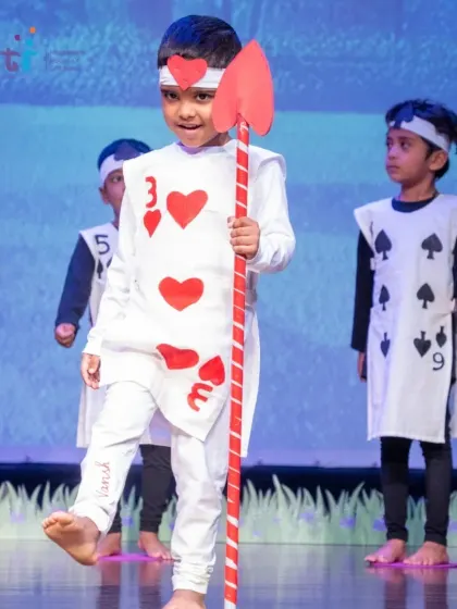 A card soldier marches proudly across the stage. The children's commitment to their roles was truly impressive.