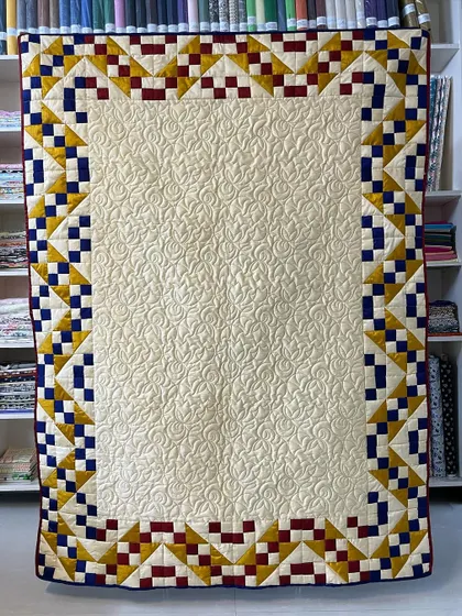 A "Jacob's Ladder" quilt made with elegant silk fabric. The back of the quilt is just as beautiful, showing the intricate quilting.