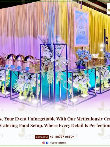 A contemporary main course station featuring a mirrored counter with illuminated floral displays set against a backdrop of golden curtains.