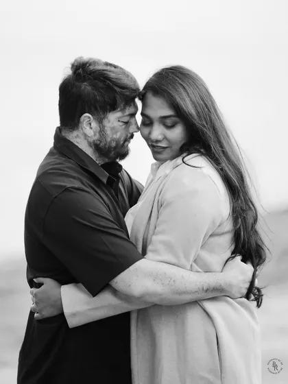 An intimate black and white portrait capturing a quiet, tender moment between the couple. This style of pre-wedding photography focuses purely on emotion.