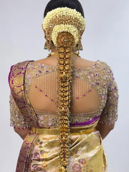 The back of the blouse is just as important as the front. This design features an intricate keyhole cutout with delicate beadwork and embroidery, ensuring the bride looks stunning from every single angle as she walks down the aisle.