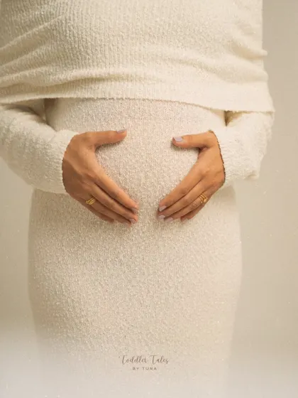 A heart for your baby. This simple, beautiful gesture of hands forming a heart on the bump is a classic for a reason. It's a pure and direct expression of love.