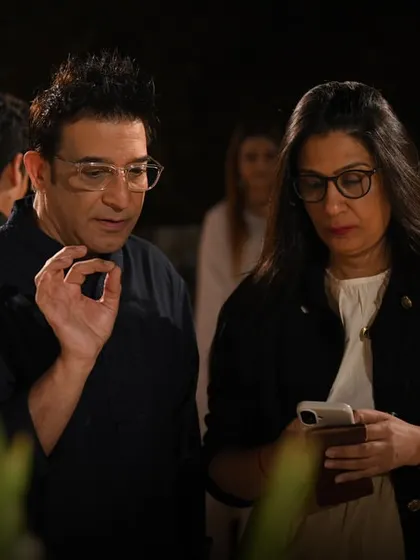 Suneet Varma discussing the intricate details of his 'Mehr' collection with a guest. Our launches provide insight into the designer's creative process.