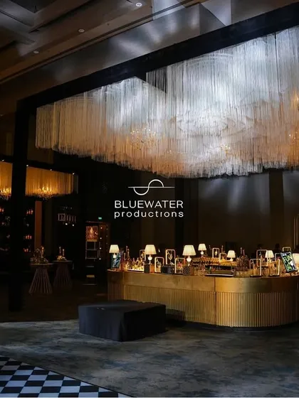Not just a bar, but an experience. This stunning island bar is topped with a massive installation of tangled silk threads and chandeliers.