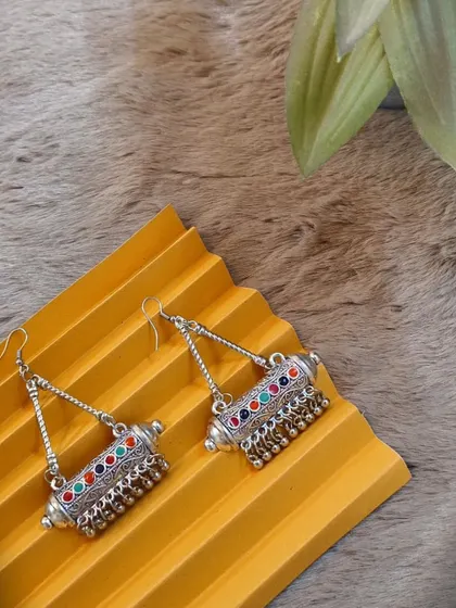 A still product shot of the multicolour embellished oxidised earrings, highlighting their unique cylindrical design and vibrant colours.
