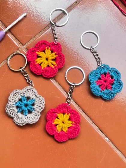 A collection of my finished flower keychains, ready to brighten up someone's day. You can see the different color combinations you can choose from. They are also available as a DIY kit.