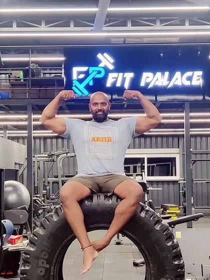 A duplicate of a powerful moment, flexing after a workout at Fit Palace.