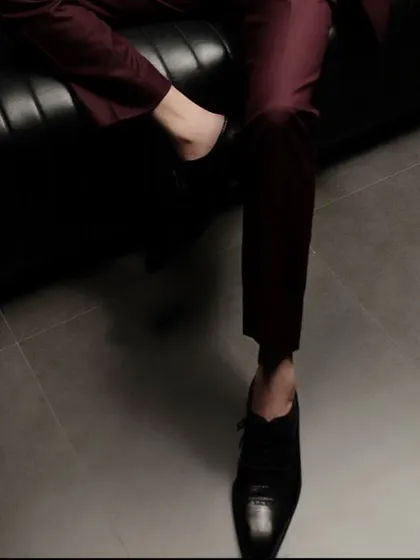 Even the details matter. The cropped trouser length and classic footwear complete this modern tuxedo look, showcasing a keen eye for style.