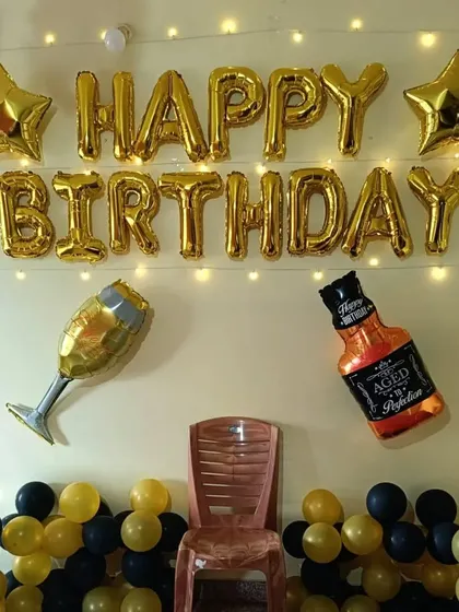Here’s a classic and stylish birthday decoration that never fails to impress. This setup features gold 'Happy Birthday' foil balloons, star accents, and fun bottle and glass-shaped balloons, all set against a backdrop of yellow and black balloons. It’s a great theme for milestone birthdays.