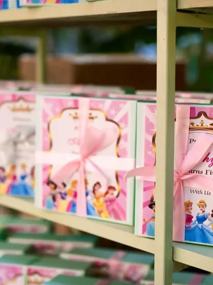 Thoughtful party favors ready for guests. These custom-designed boxes, featuring a princess theme and tied with a pink ribbon, are a perfect takeaway to remember the magical day.