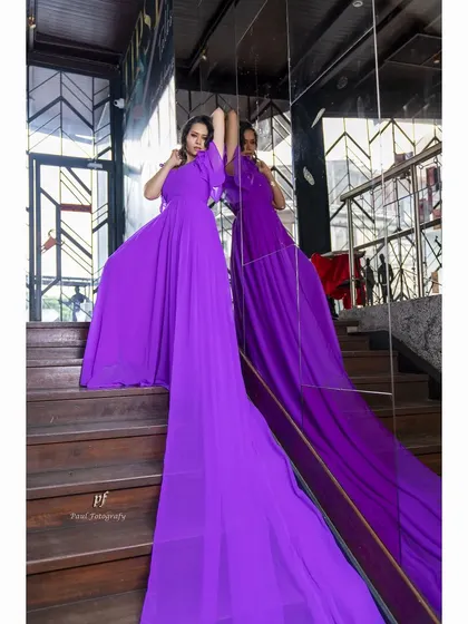 Another shot of the purple gown on the staircase, capturing its vibrant color and elegant design.