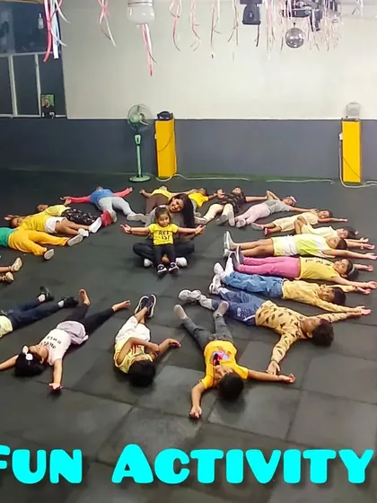 An instructor joins the kids in their sunburst formation. These team-building activities are great for fostering cooperation and friendship.