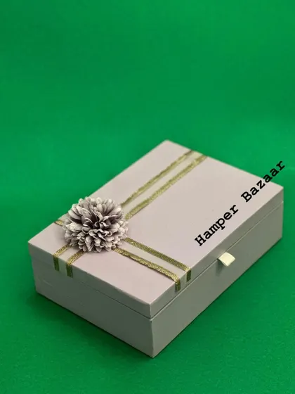 The exterior of our elegant corporate wellness hamper. The simple, sophisticated design of the box makes it suitable for any professional occasion, from employee appreciation to client thank you gifts.