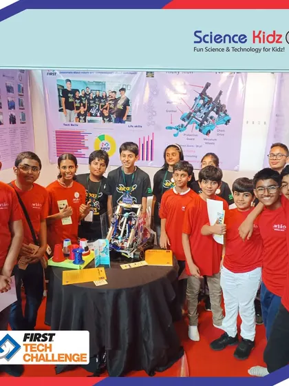 The full team of our young engineers at the FIRST Tech Challenge India Championship in Pune, standing by their complex robot and project display.