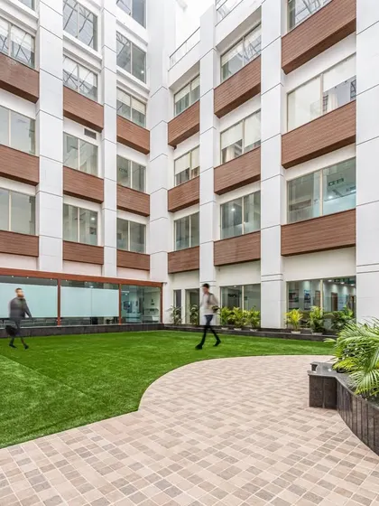 Another view of the courtyard at Sarvesh Health City, showing how it is enclosed by the building. This design visually connects key services like the outpatient departments and emergency services, improving wayfinding and operational flow.