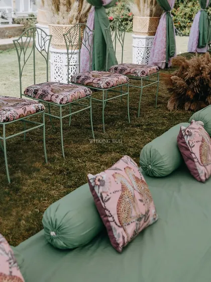 Going floral-free with a nod to nature. This seating arrangement combines green floor cushions with leopard-print throw pillows and wrought-iron stools, creating a unique jungle-inspired theme.