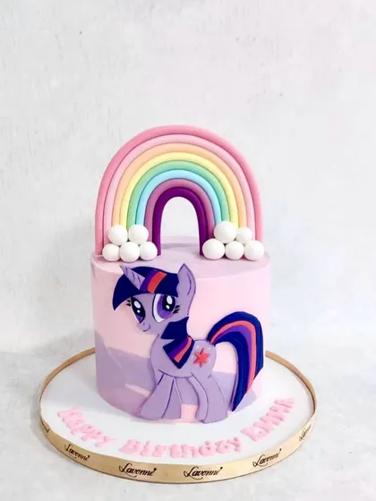 A My Little Pony cake featuring Twilight Sparkle. The cake is decorated with a big fondant rainbow and fluffy clouds.