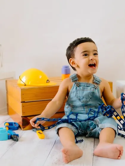 Little builder at work! With a hard hat and tools, this little one is ready to construct some fun and create some adorable memories.